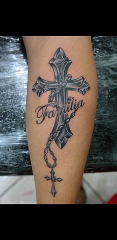 a cross with the word faith on it and a rosary hanging from it's side