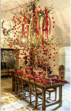 a dining room table with red decorations on it