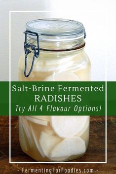 a mason jar filled with sliced apples on top of a wooden table