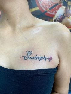 a woman with a tattoo on her chest that says sandeep and has hearts