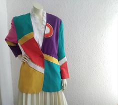 80s pop-art blazer colorful blazer color block jacket linen multicolor blazer 12 US size gold trim blazer embellished sequined blazer GOOD VINTAGE CONDITION BUT THE BLAZER IS NOT DRY CLEAN.  The blazer is 100% linen and viscose lining.  The color are not extremely vivid like apear in the photos, because of age and use. Measurement laiyng flat:  Shoulders:45 cm ( 17.5inches) Bust:52 cm ( 20.5 inches) Waist: 49 cm ( 19.5 inches) Total lenght: 75 cm (29.5 inches) Sleeve lenght:61 cm ( 24 inches) Trendy Fitted Multicolor Blazer, Trendy Multicolor Winter Blazer, Retro Multicolor Blazer For Fall, Retro Multicolor Fall Blazer, Spring Multicolor Cotton Blazer, Trendy Multicolor Summer Blazer, Vintage Multicolor Blazer For Spring, Spring Multicolor Patchwork Blazer, Spring Vintage Multicolor Blazer