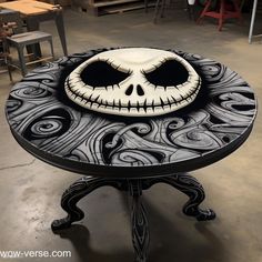 a black and white table with a jack skelling face painted on it's top