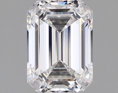 an emerald cut diamond on a gray background