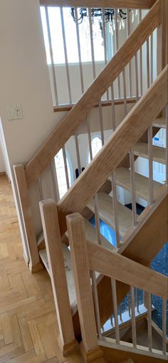 the stairs are made of wood and have glass balconies