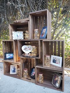 several wooden crates are stacked on top of each other with pictures and frames in them