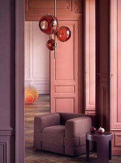 a living room with pink walls and furniture in the corner, as well as an orange lamp