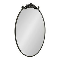 an oval mirror with black metal frame