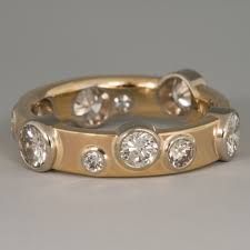 a yellow gold ring with five diamonds