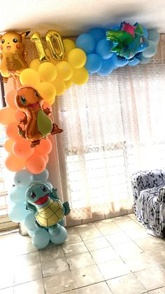 the balloons are all over the room and there is a turtle balloon on the wall