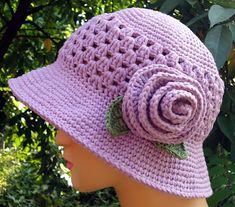 a crocheted hat with a rose on it