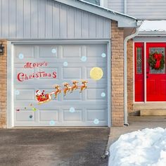 a garage decorated for christmas with santa's sleigh and reindeers on it