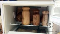 an open refrigerator filled with lots of wooden utensils