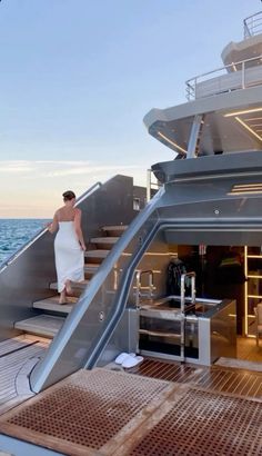 a woman is walking up the stairs on a boat