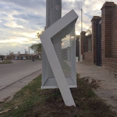 a white sculpture sitting on the side of a road