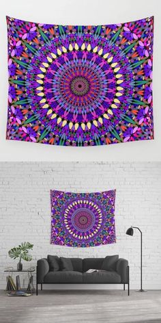 a colorful tapestry hanging on the wall above a couch