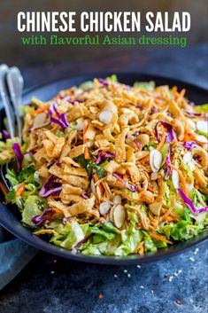 chicken salad with carrots, lettuce and almonds in a blue bowl