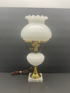 a white lamp sitting on top of a table