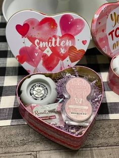 two heart shaped tins sitting on top of a table