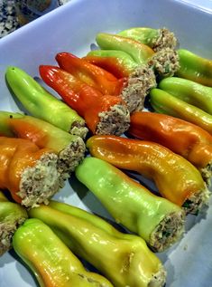 several peppers are arranged in a row on a plate