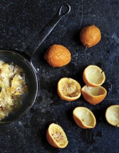 an image of food that is being cooked on the stove top with lemons around it