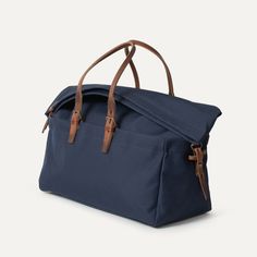 Cabine Travel bag - Navy Blue | Bleu de chauffe Casual Shoulder Bag For Overnight Trips With Adjustable Strap, Casual Shoulder Bag With Adjustable Strap For Overnight Trips, Blue Large Capacity Backpack For Travel, Large Capacity Blue Backpack For Travel, Blue Casual Travel Bag With Large Capacity, Casual Blue Large Capacity Travel Bag, Casual Blue Travel Bag With Large Capacity, Casual Travel Luggage With Top Carry Handle, Casual Bags With Adjustable Strap For Overnight Trips