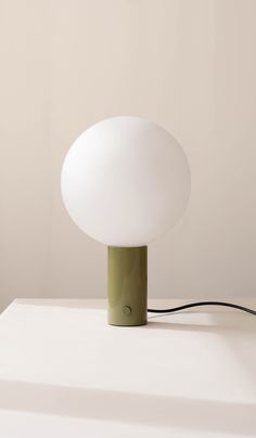 a table lamp sitting on top of a white surface