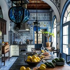 a kitchen with blue and white tiles on the walls