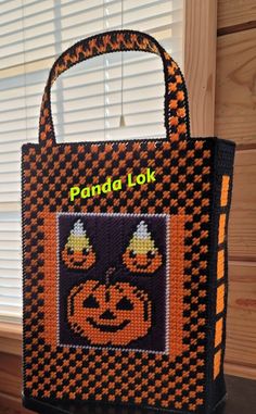 a bag made to look like a pumpkin with the words panda lok on it