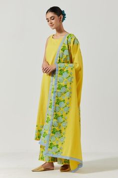 Yellow cotton mul round neck kurta with floral print detailing on hemline. Comes with palazzo and dupatta.
Component: 3
Pattern: Printed
Type Of Work: Floral
Neckline: Round
Sleeve Type: Sleeveless
Fabric: Cotton Mul
Color: Yellow
Other Details: 
Floral print details
Round neckline
Occasion: Mehendi and Haldi - Aza Fashions Summer Dupatta With Printed Motifs, Sleeveless Cotton Kurta With Floral Embroidery, Spring Block Print Dupatta, Summer Floral Print Dupatta, Yellow Cotton Dupatta For Summer, Summer Yellow Dupatta With Printed Motifs, Kurta Set For Women, Types Of Work, Kurta Set