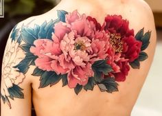 the back of a woman's shoulder with flowers on it