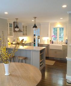 a kitchen with an island and wooden floors