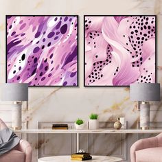 two paintings on the wall in a living room with pink chairs and a coffee table