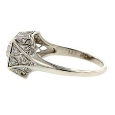 an antique style diamond ring on a white background