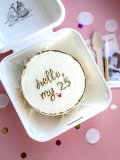 a cake in a box with the words hello my 25 written on it