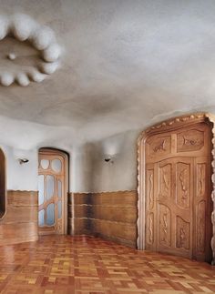 an empty room with wooden floors and doors