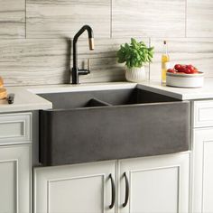 a kitchen sink sitting under a faucet on top of a counter next to a cutting board