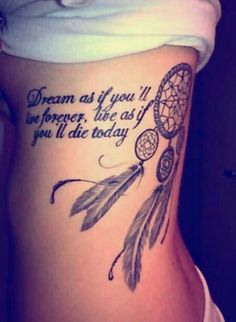 the back of a woman's stomach with a tattoo saying dream as if you were there