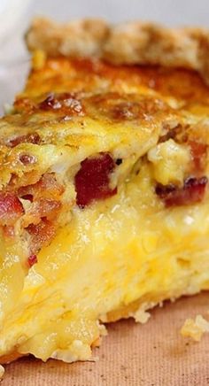 a piece of quiche sitting on top of a wooden cutting board