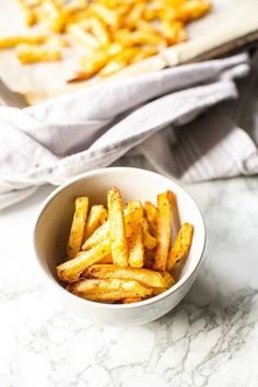 the best mexican fries in a white bowl on a marble counter with text overlay