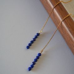 Real blue lapis lazuli gems have been hand crafted into these elegant threaders in 14k gold filled. Simple and ultra dainty, the perfect earrings for everyday wear. ♥ Material: Metal- Made from 14k gold filled  threaders(not gold plated!) Gemstone- 3.5mm realblue lapis lazuli beads ♥ Size:   length- 110mm whole, 26mm drop width-3.5mm ♥ Package: To avoid over packaging and protect our environment,  all the package materials are environmental friendly and can be fully recycled or compostable ♥ Del Minimalist Adjustable Lapis Lazuli Jewelry, Adjustable Minimalist Lapis Lazuli Jewelry, Yellow Gold Lapis Lazuli Minimalist Jewelry, Minimalist Yellow Gold Lapis Lazuli Jewelry, Blue 14k Gold-filled Wire Wrapped Jewelry, Blue 14k Gold Filled Wire Wrapped Jewelry, Lapis Lazuli Beads, Dainty Chain, Environmental Friendly