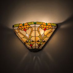 a stained glass light fixture on the wall