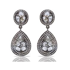 A dazzling melange of Diamonds in contrasting grey and white hues in a contemporary interpretation of classic Jaipur design on the most spectacular chandelier earrings.- Grey Diamonds weight approx 2.80 Carats.- White Diamonds weight approx 1.80 Carats.- Set in Blackened Oxidized Silver. Luxury Teardrop Diamond Earrings With Single Cut Diamonds, Luxury Rose Cut Drop Diamond Earrings, Hand Set Diamond White Teardrop Diamond Earrings, Hand Set Diamond White Teardrop Earrings, Luxury Rose Cut Diamond Drop Earrings, Hand-set White Diamond Teardrop Earrings, Luxury Rose Cut Diamond Dangle Earrings, Luxury Silver Chandelier Earrings With Rose Cut Diamonds, Diamond White Teardrop Rose Cut Diamond Earrings