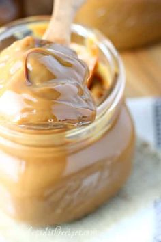 a jar filled with peanut butter sitting on top of a table