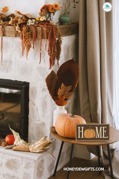 a fireplace decorated for fall with pumpkins and other autumn decorations on the mantel