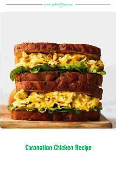 an image of a sandwich with chicken and lettuce on it that is stacked high in the air