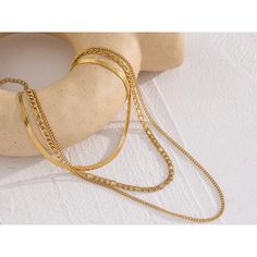 Channel your inner fashion icon with the Cascading Trio Necklace Set. This versatile set features three separate chains in varying lengths, each crafted from high-quality, tarnish-resistant stainless steel with a gleaming gold plating. The cascading design creates a beautiful layered effect, allowing you to personalize your look and add a touch of modern elegance to any outfit. Plus, the waterproof construction ensures you can wear it worry-free. Material: Stainless Steel with Gold Plating Three Separate Adjustable Chains:Necklace 1: 13.5" + 2" extensionNecklace 2: 16" + 2" extensionNecklace 3: 18" + 2" extension Waterproof & Tarnish-Resistant Mix and match the chains or wear them all together for a truly captivating look! Chain Layered Necklace, Triple Layer Necklace, Trio Necklace, Layered Choker Necklace, Layered Chain Necklace, Layered Chokers, Layered Necklace Set, Unisex Necklace, Layered Chains