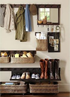 an organized entryway with baskets and boots