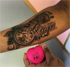 a person holding a pink heart with an alarm clock on it and the words reagan written in cursive writing