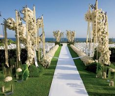 an outdoor wedding setup with white flowers and greenery