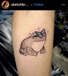 a frog with a butterfly on it's head is shown in this tattoo design